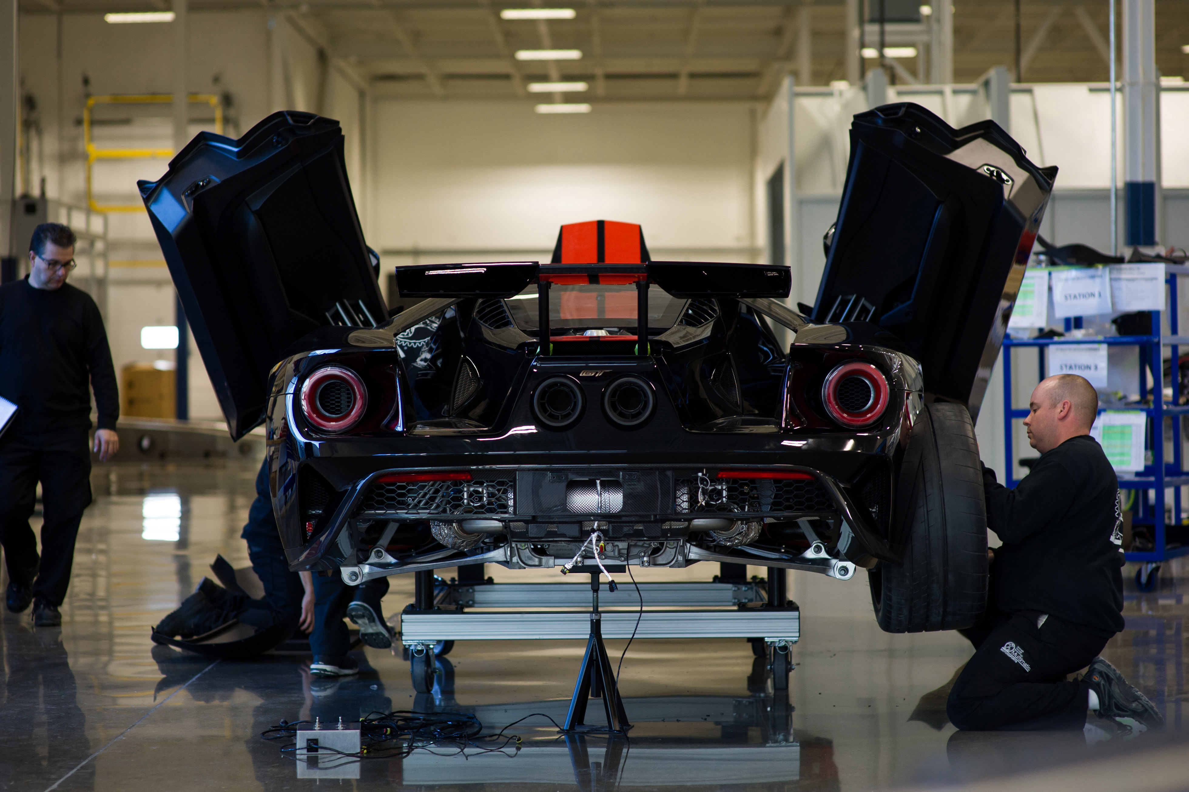 MARKHAM, Ontario, Canada, Dec. 16, 2016--The all-new Ford GT is entering the final phase of development and production has begun. One of the first Ford GTs is being driven off the line at the Multimatic assembly location with the first behind the scenes look at the assembly line for all-new Ford GT. The Ford GT is the culmination of years of Ford innovation in aerodynamics, lightweight carbon fiber construction and ultra-efficient EcoBoost engines. Pictured: Anthony Benincasa (left) and Adam Thorndyke. Photo by: Nick Busato