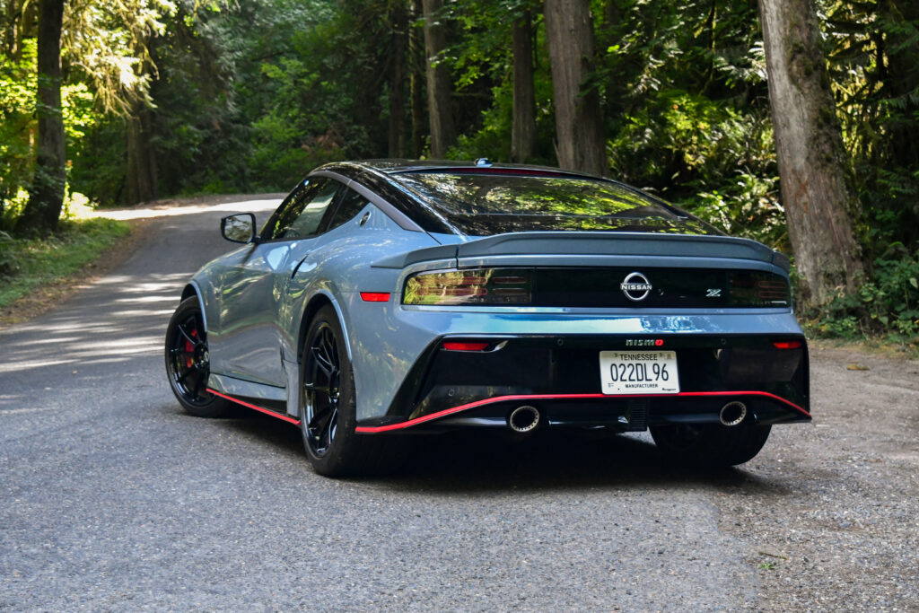 The rear end of a 2024 Nissan Z Nismo parked on a forest road