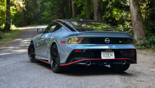 The rear end of a 2024 Nissan Z Nismo parked on a forest road